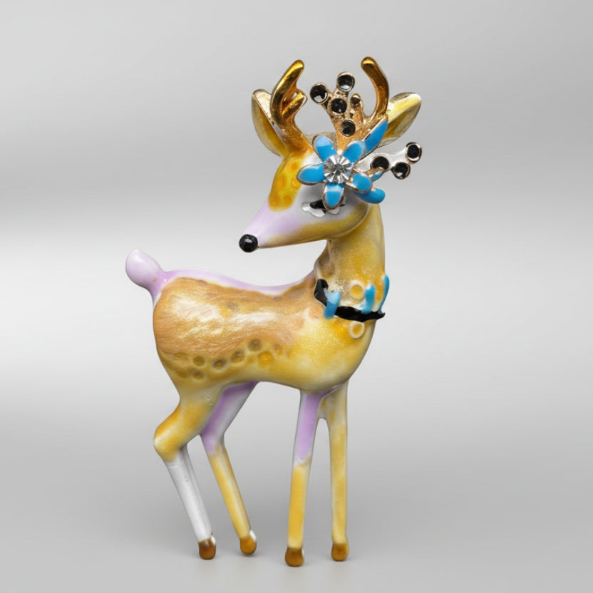 Decorative deer brooch with colorful antlers on a light gray background