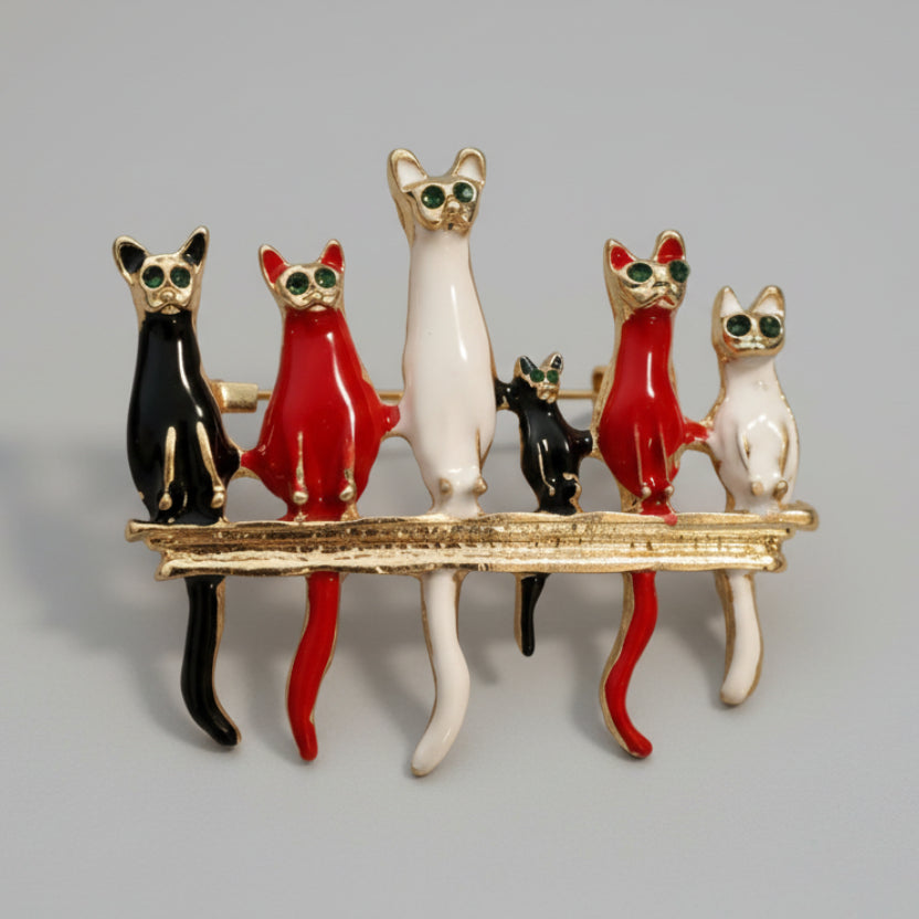 Colorful six-cat shaped brooch on a light gray background